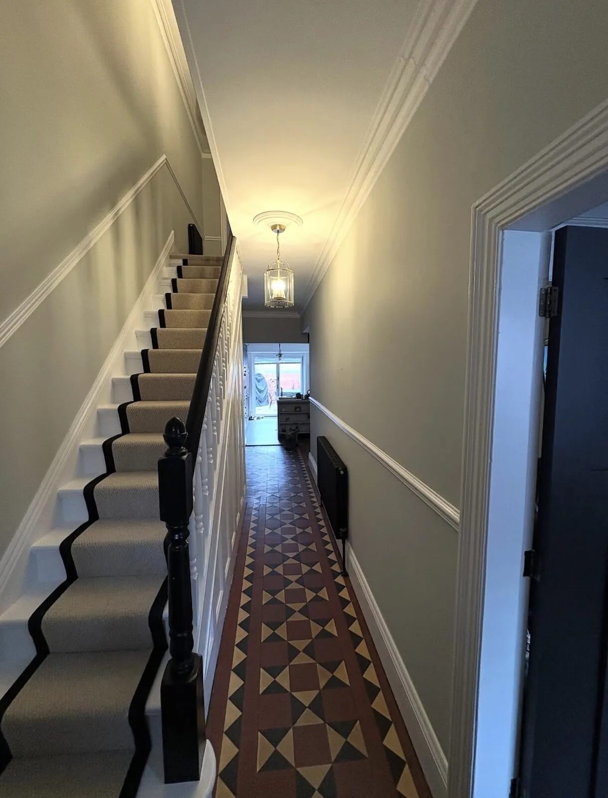 Period hallway with painted staircase, dado rail and original floor tiles