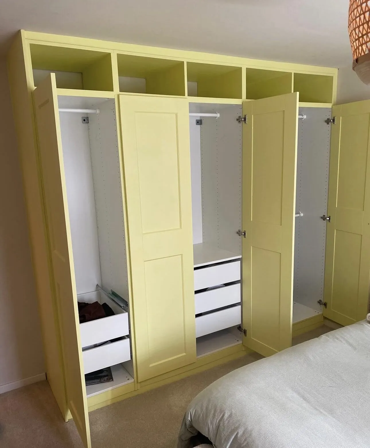 Fitted bedroom wardrobes sprayed in a soft yellow finish